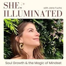 Cover image for Podcast titled She Illuminated by Jano Fuchs, featuring a woman with long brown hair and earrings, smiling outdoors with greenery in the background, and subtitle Soul Growth & the Magic of Mindset.