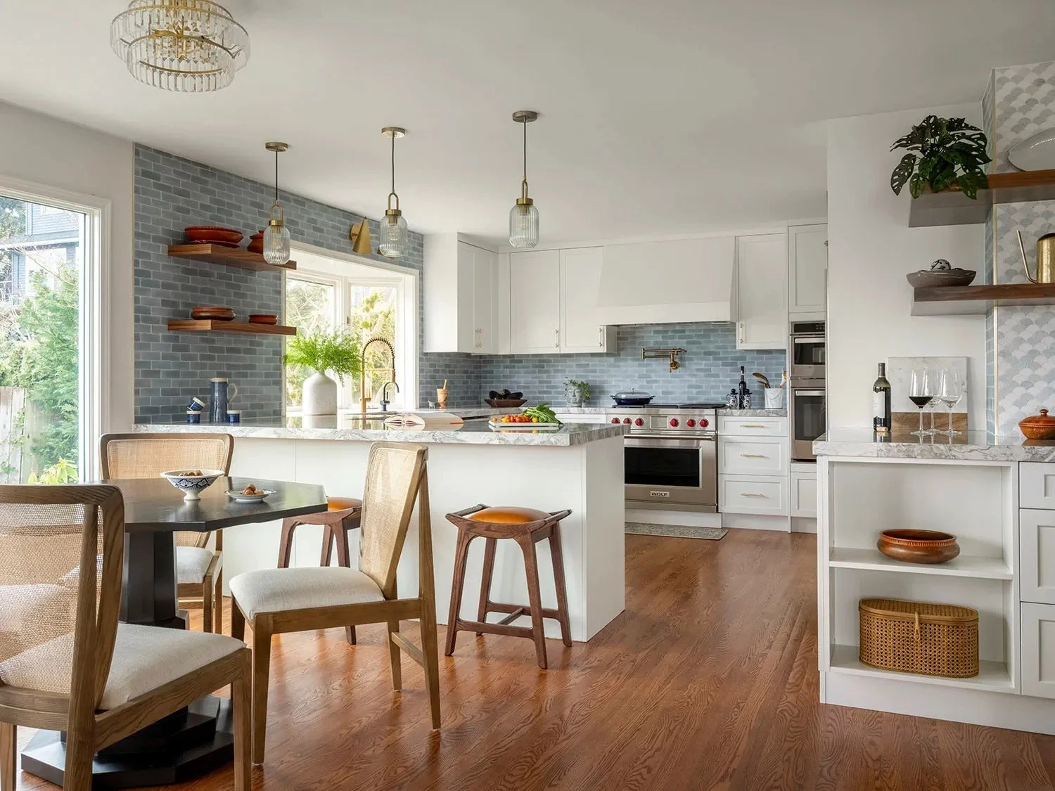 White custom cabinetry keeps the main space feeling open, while the blue-gray glazed tile backsplash