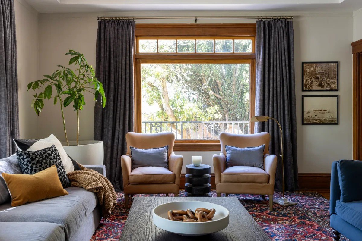 A classic Tudor Revival home in Tonawanda thoughtfully updated for a growing family through layered artwork, custom built-ins, rich color, family-friendly furniture, and a considered mix of traditional and modern design.
