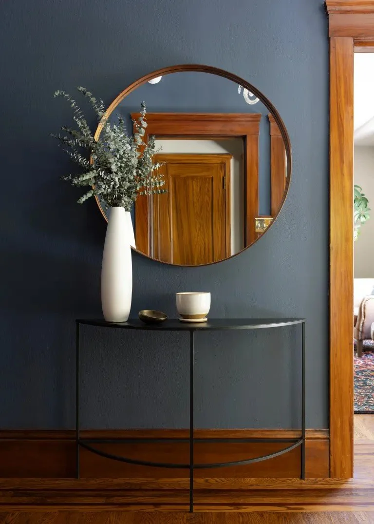 A classic Tudor Revival home in Tonawanda thoughtfully updated for a growing family through layered artwork, custom built-ins, rich color, family-friendly furniture, and a considered mix of traditional and modern design.