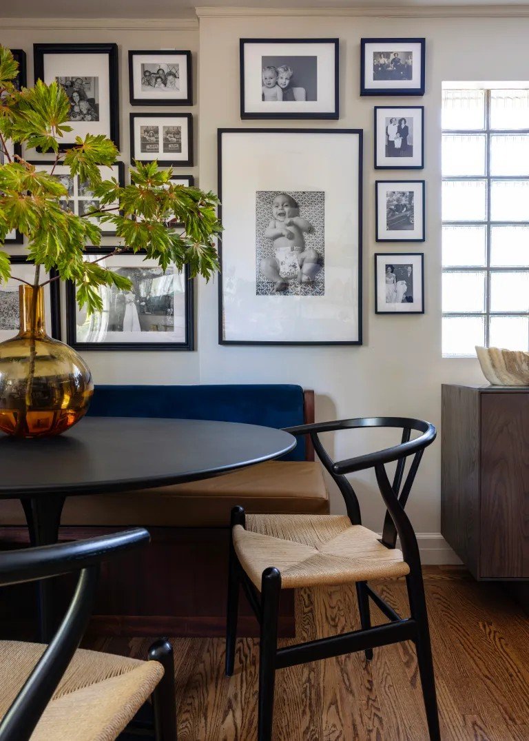 A classic Tudor Revival home in Tonawanda thoughtfully updated for a growing family through layered artwork, custom built-ins, rich color, family-friendly furniture, and a considered mix of traditional and modern design.