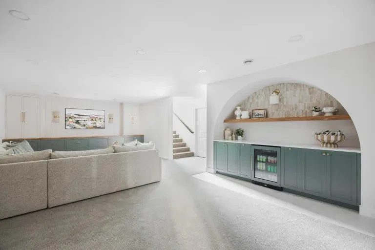 When designing this Williamsville, NY living room, we wanted to bring attention to the space by using bright accents and artworks that sparked joy. This couple is was looking for a creative solution to the space for their family.