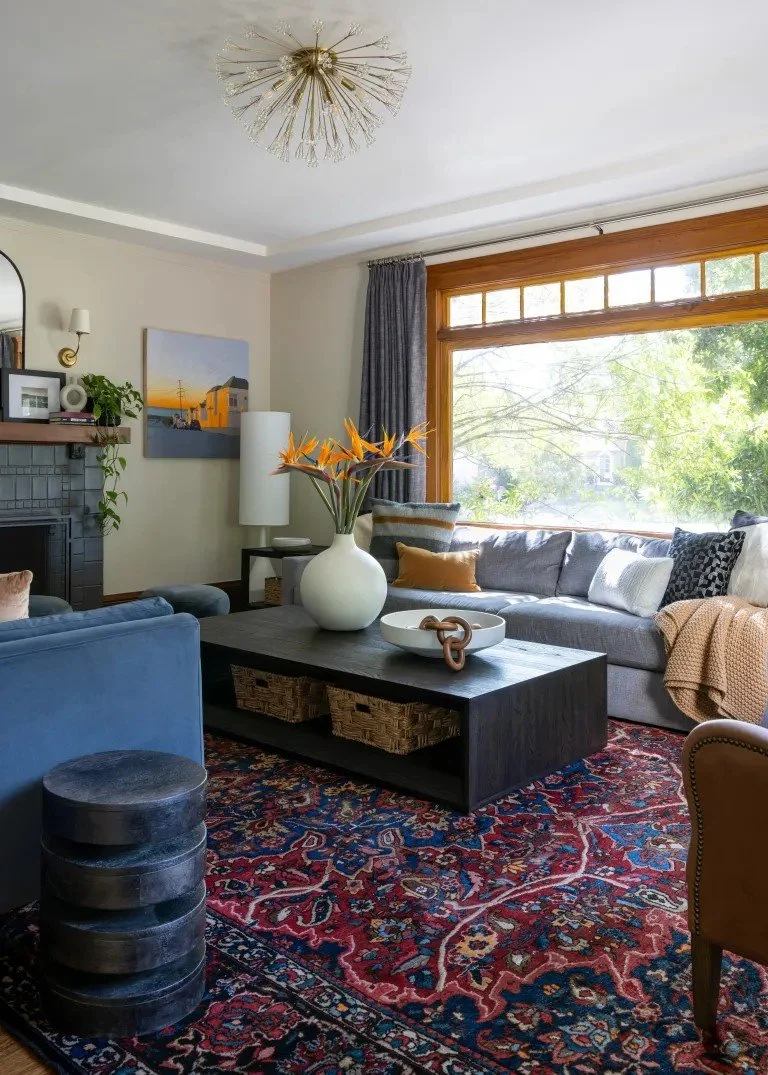 A classic Tudor Revival home in Tonawanda thoughtfully updated for a growing family through layered artwork, custom built-ins, rich color, family-friendly furniture, and a considered mix of traditional and modern design.