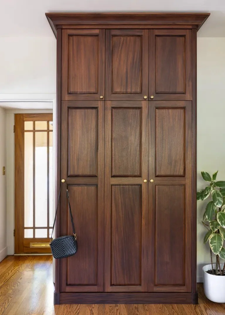 A classic Tudor Revival home in Tonawanda thoughtfully updated for a growing family through layered artwork, custom built-ins, rich color, family-friendly furniture, and a considered mix of traditional and modern design.