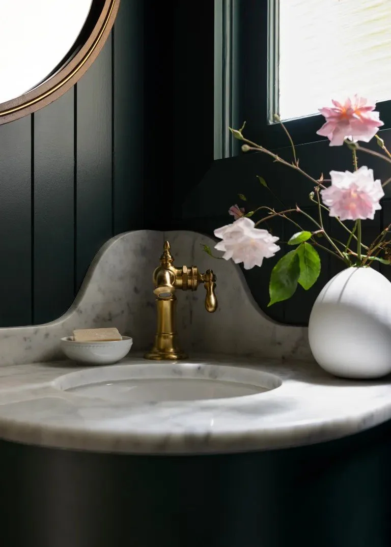 A classic Tudor Revival home in Tonawanda thoughtfully updated for a growing family through layered artwork, custom built-ins, rich color, family-friendly furniture, and a considered mix of traditional and modern design.