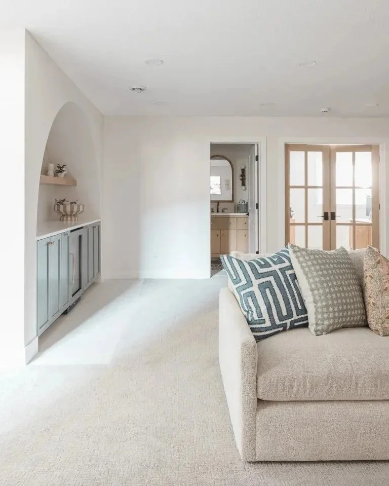 When designing this Williamsville, NY living room, we wanted to bring attention to the space by using bright accents and artworks that sparked joy.