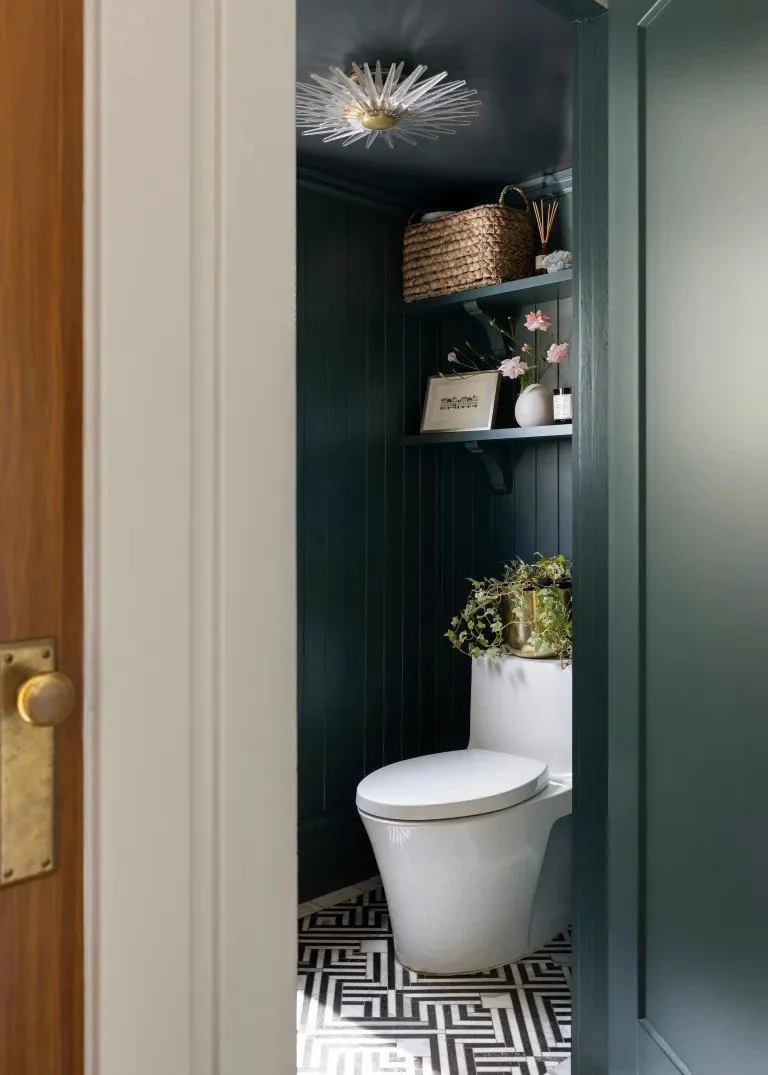 A classic Tudor Revival home in Tonawanda thoughtfully updated for a growing family through layered artwork, custom built-ins, rich color, family-friendly furniture, and a considered mix of traditional and modern design.