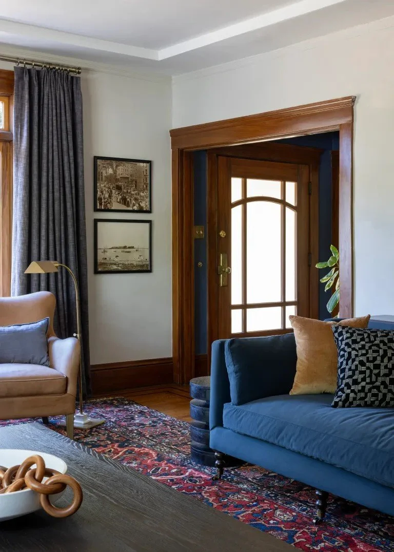 A classic Tudor Revival home in Tonawanda thoughtfully updated for a growing family through layered artwork, custom built-ins, rich color, family-friendly furniture, and a considered mix of traditional and modern design.