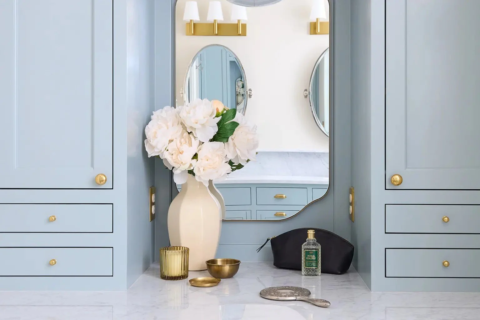 A modern-traditional primary suite renovation in Buffalo’s Allentown neighborhood, blending soft floral pattern, custom built-ins, refreshed cabinetry, classic tile, and contemporary furnishings for a young family.