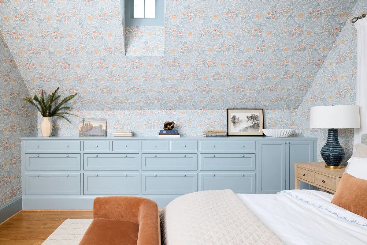 A modern-traditional primary suite renovation in Buffalo’s Allentown neighborhood, blending soft floral pattern, custom built-ins, refreshed cabinetry, classic tile, and contemporary furnishings for a young family.