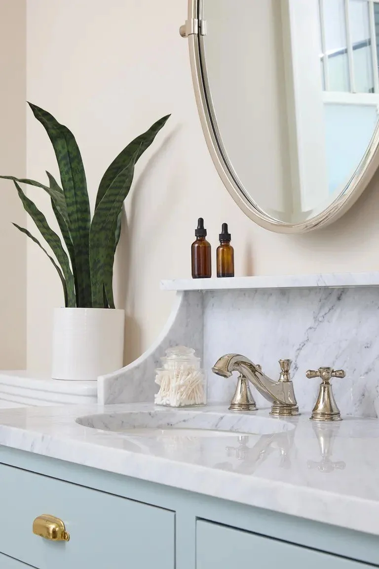 A modern-traditional primary suite renovation in Buffalo’s Allentown neighborhood, blending soft floral pattern, custom built-ins, refreshed cabinetry, classic tile, and contemporary furnishings for a young family.