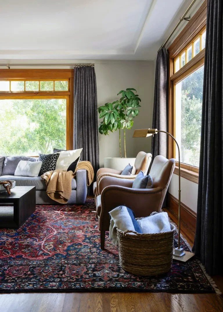 A classic Tudor Revival home in Tonawanda thoughtfully updated for a growing family through layered artwork, custom built-ins, rich color, family-friendly furniture, and a considered mix of traditional and modern design.