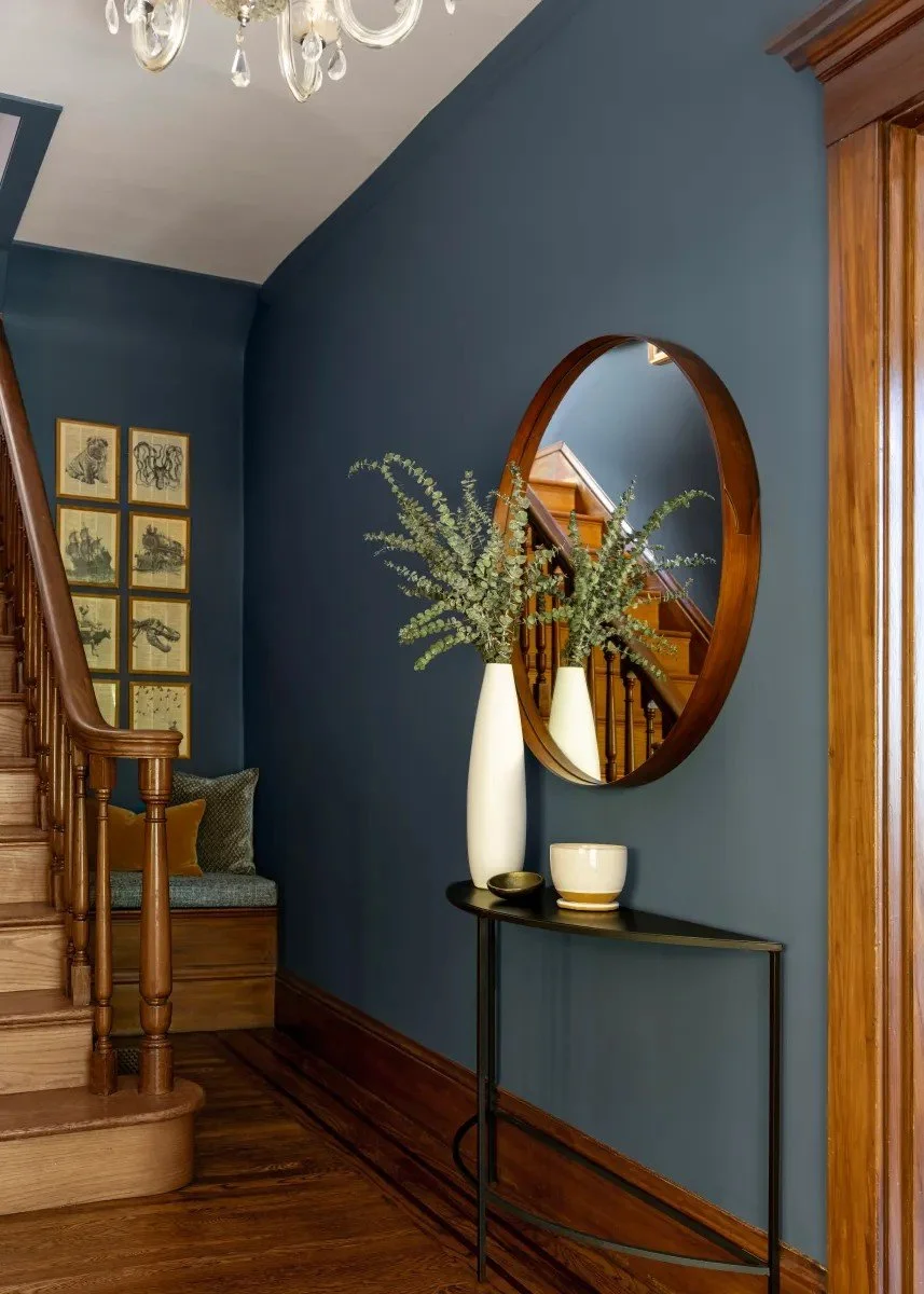 A classic Tudor Revival home in Tonawanda thoughtfully updated for a growing family through layered artwork, custom built-ins, rich color, family-friendly furniture, and a considered mix of traditional and modern design.