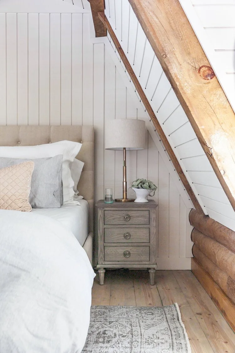 This custom attic renovation in East Aurora, NY transformed an underutilized upper level into a warm, functional, and thoughtfully designed bedroom retreat complete with a private en suite bathroom.