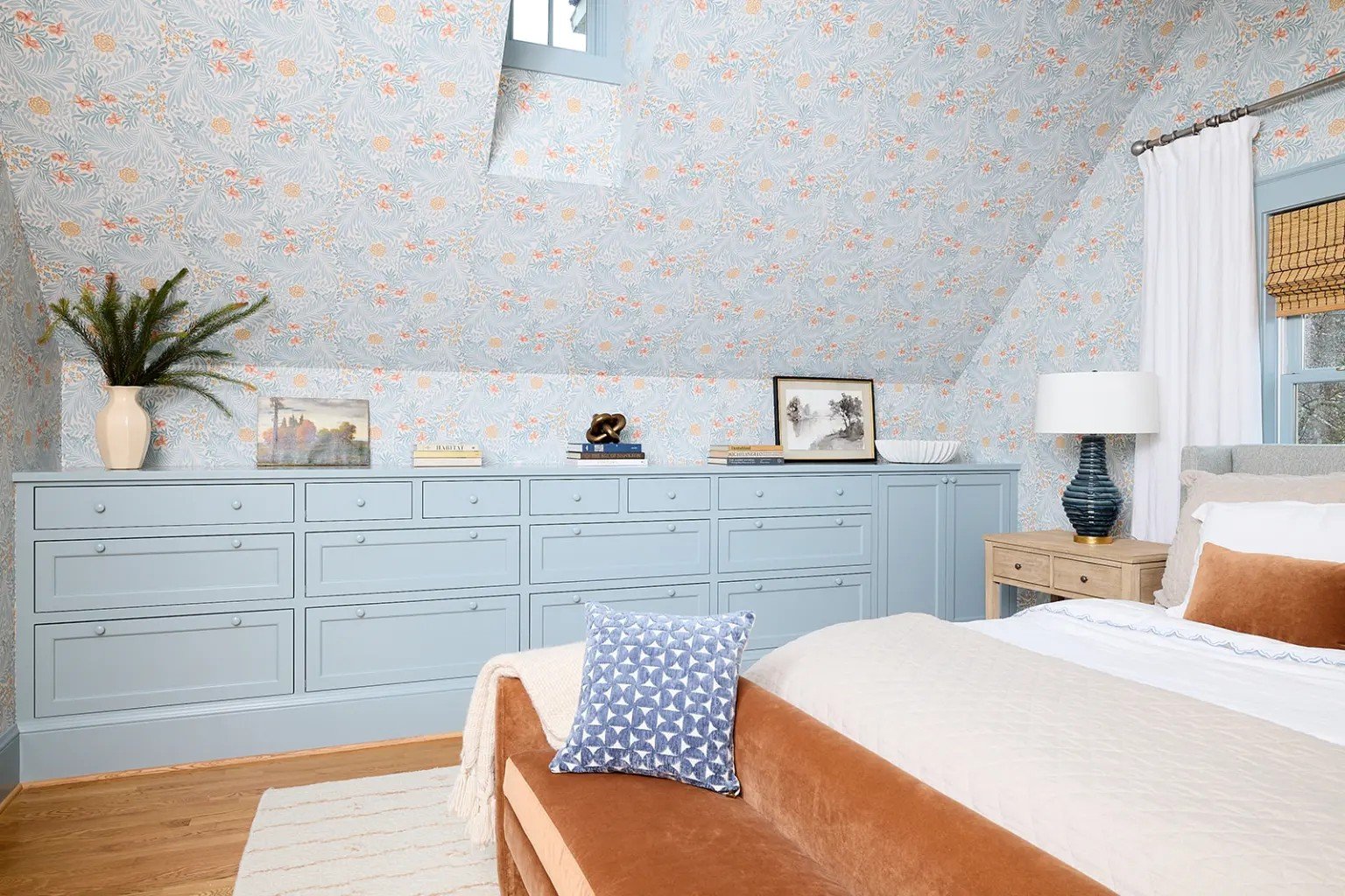 A modern-traditional primary suite renovation in Buffalo’s Allentown neighborhood, blending soft floral pattern, custom built-ins, refreshed cabinetry, classic tile, and contemporary furnishings for a young family.