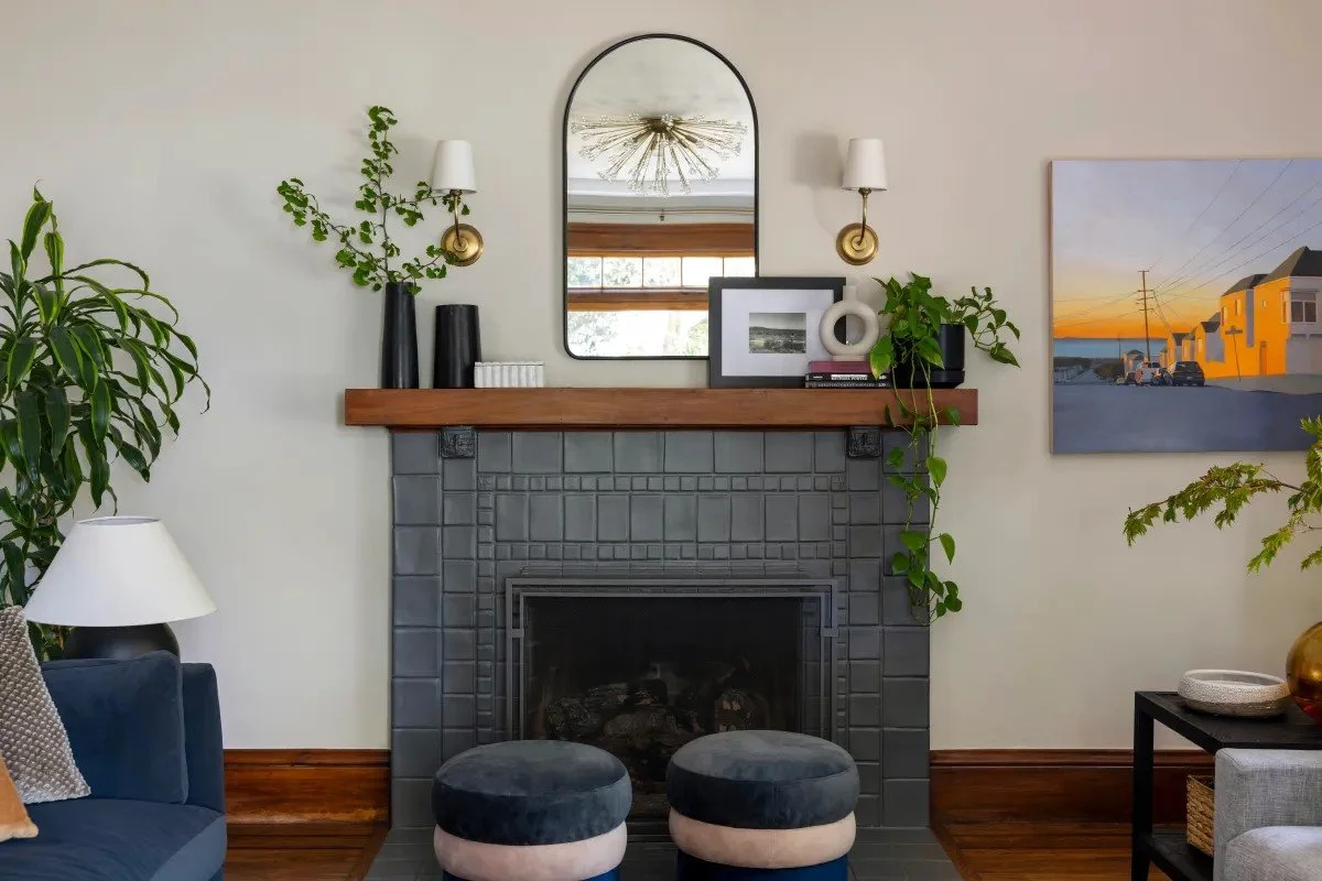 A classic Tudor Revival home in Tonawanda thoughtfully updated for a growing family through layered artwork, custom built-ins, rich color, family-friendly furniture, and a considered mix of traditional and modern design.