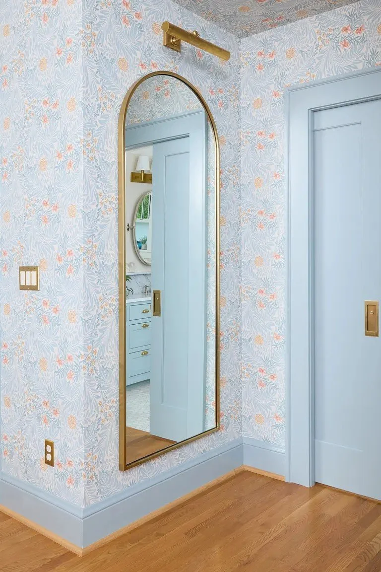 A modern-traditional primary suite renovation in Buffalo’s Allentown neighborhood, blending soft floral pattern, custom built-ins, refreshed cabinetry, classic tile, and contemporary furnishings for a young family.