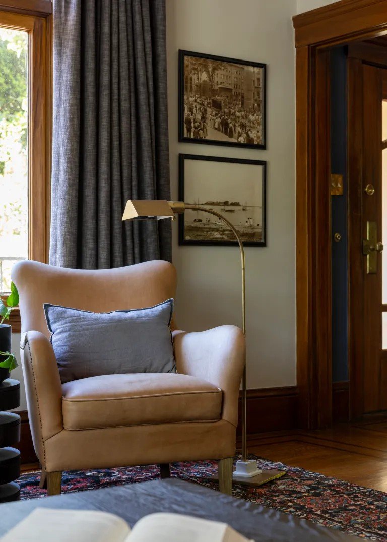 A classic Tudor Revival home in Tonawanda thoughtfully updated for a growing family through layered artwork, custom built-ins, rich color, family-friendly furniture, and a considered mix of traditional and modern design.