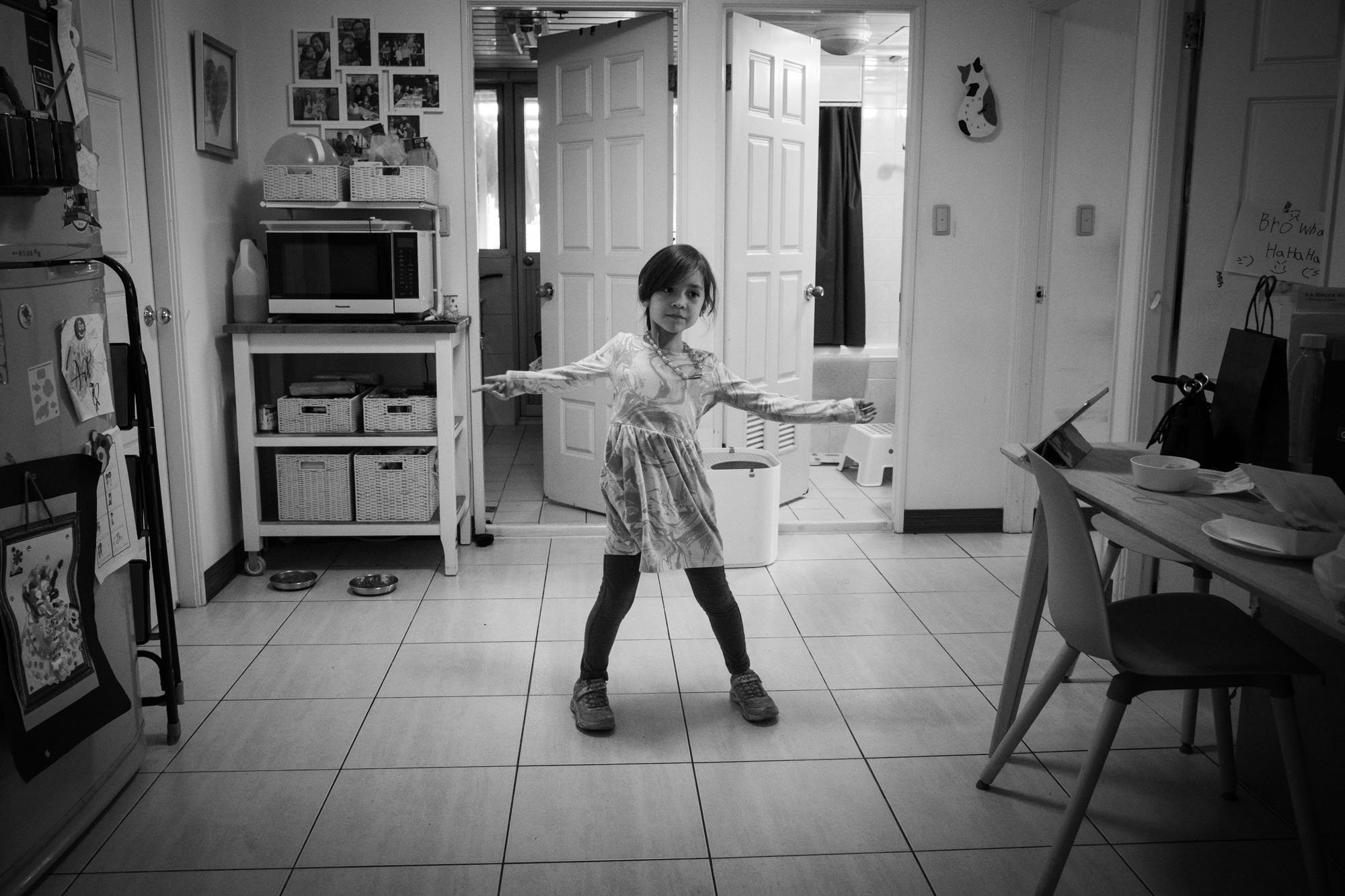 A little girl dances in her dining room in Taipei, Taiwan.
