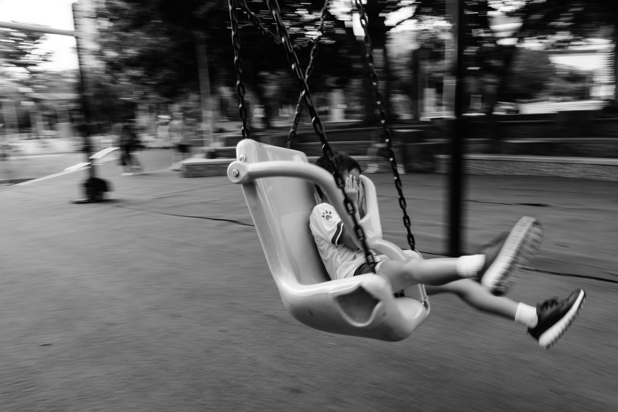 A little boy going fast on a zipline at a park in Taipei, Taiwan.