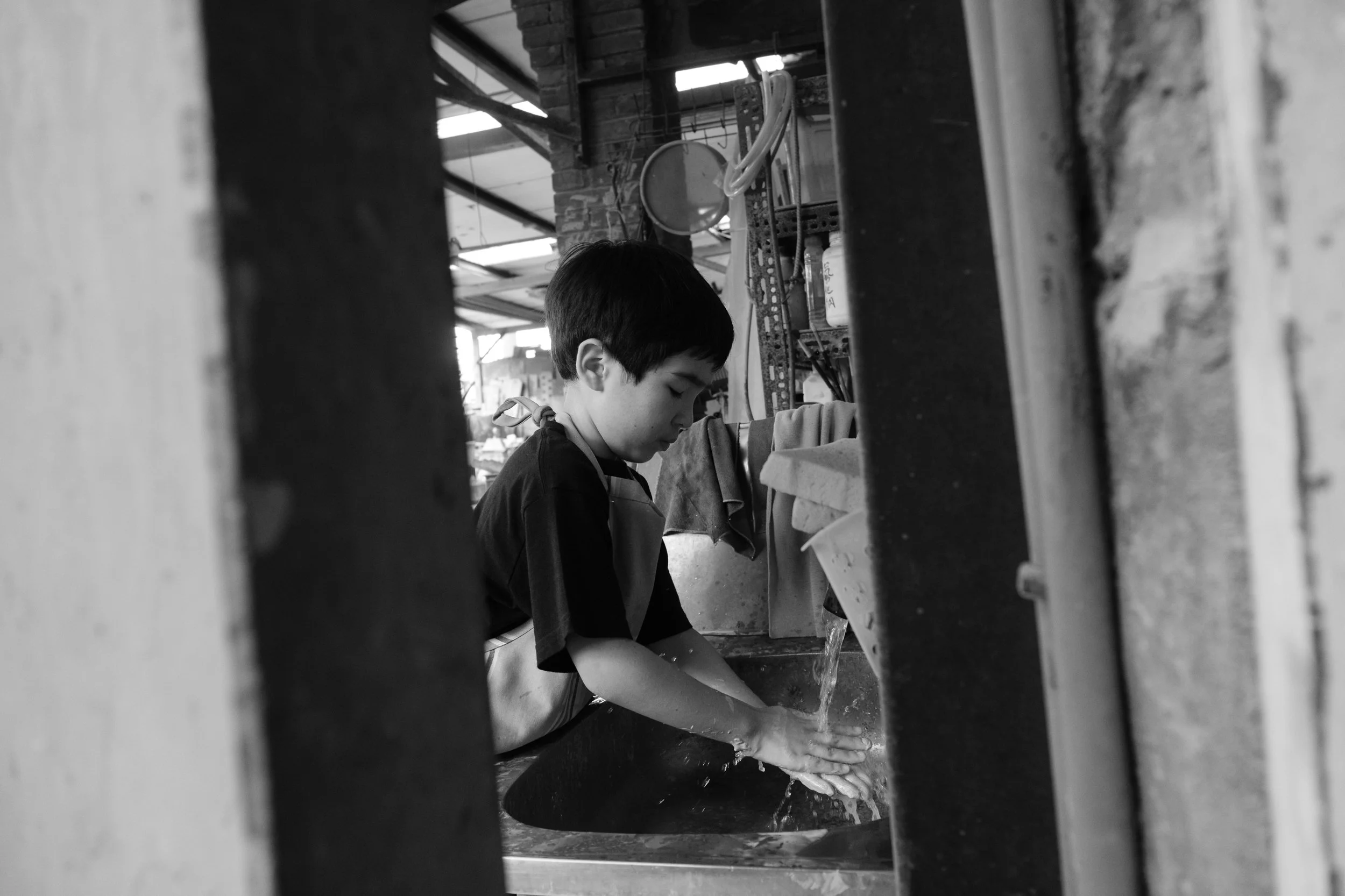 A little boy washes his hands after working with clay in an Yingge DIY ceramics class in Taiwan.