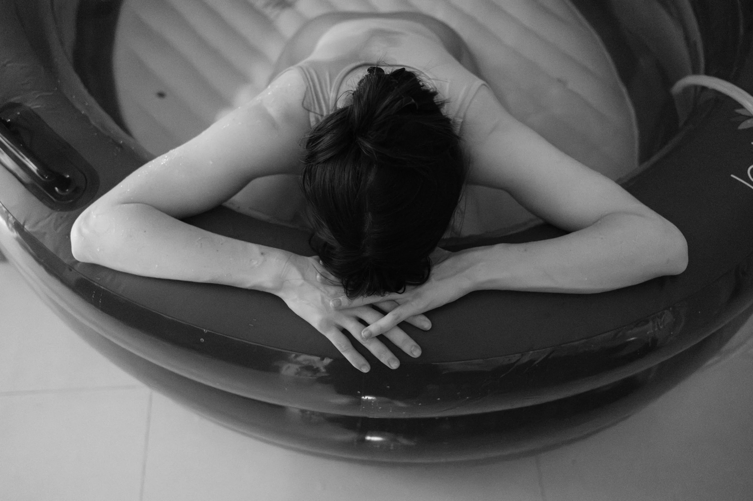 Mother laboring in the birth pool during a home water birth in Taipei