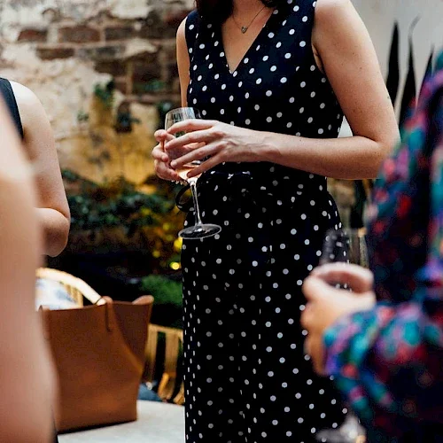 Woman in crowd holding wine glass