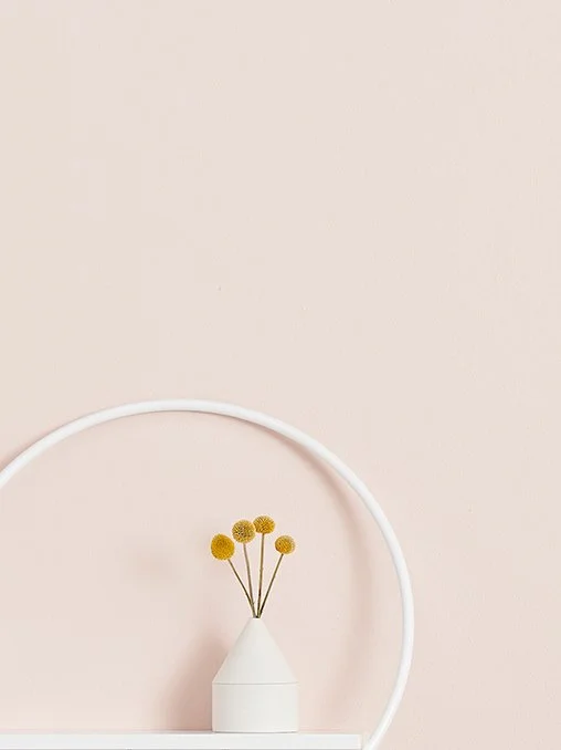 Round white shelf on the wall