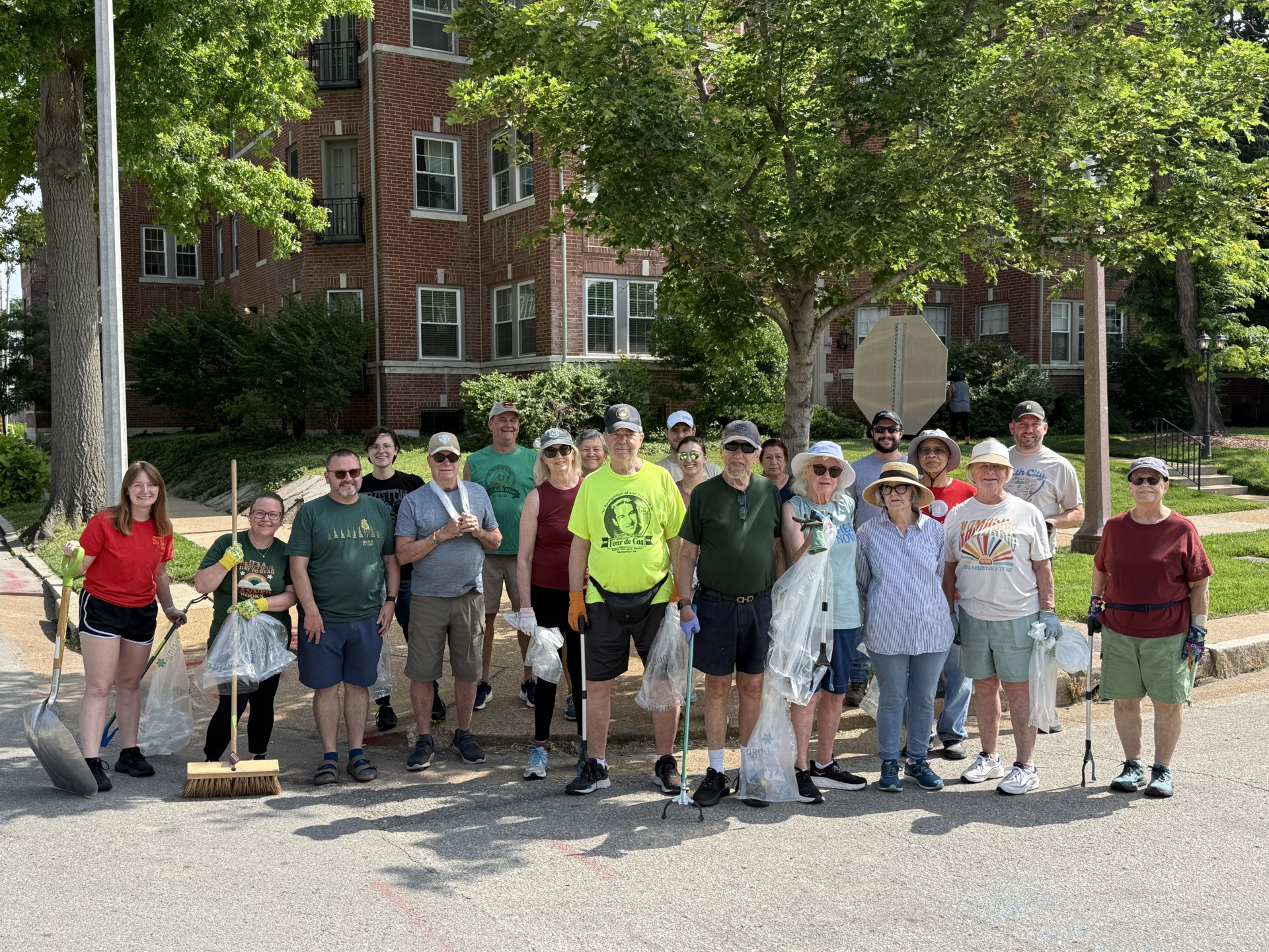 A group of DeBaliviere Place residents gather with shovels, rakes, and other implements of destruction to help clean the neighborhood.