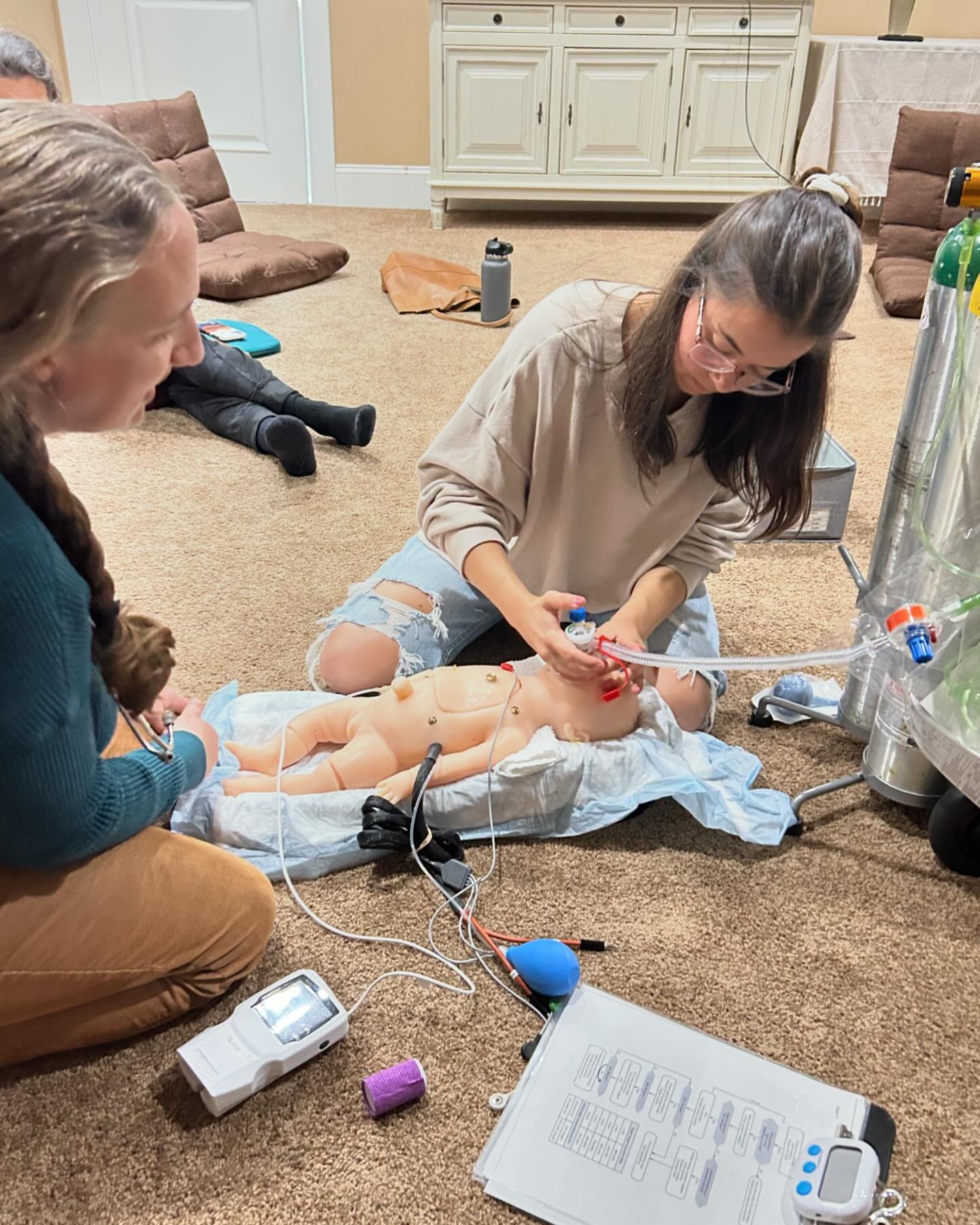 Running frequent emergency drills to keep our skills sharp is an important part of our practice! Here our birth assistants Mandy and Sin&eacute;ad practice NRP (neonatal resuscitation).
