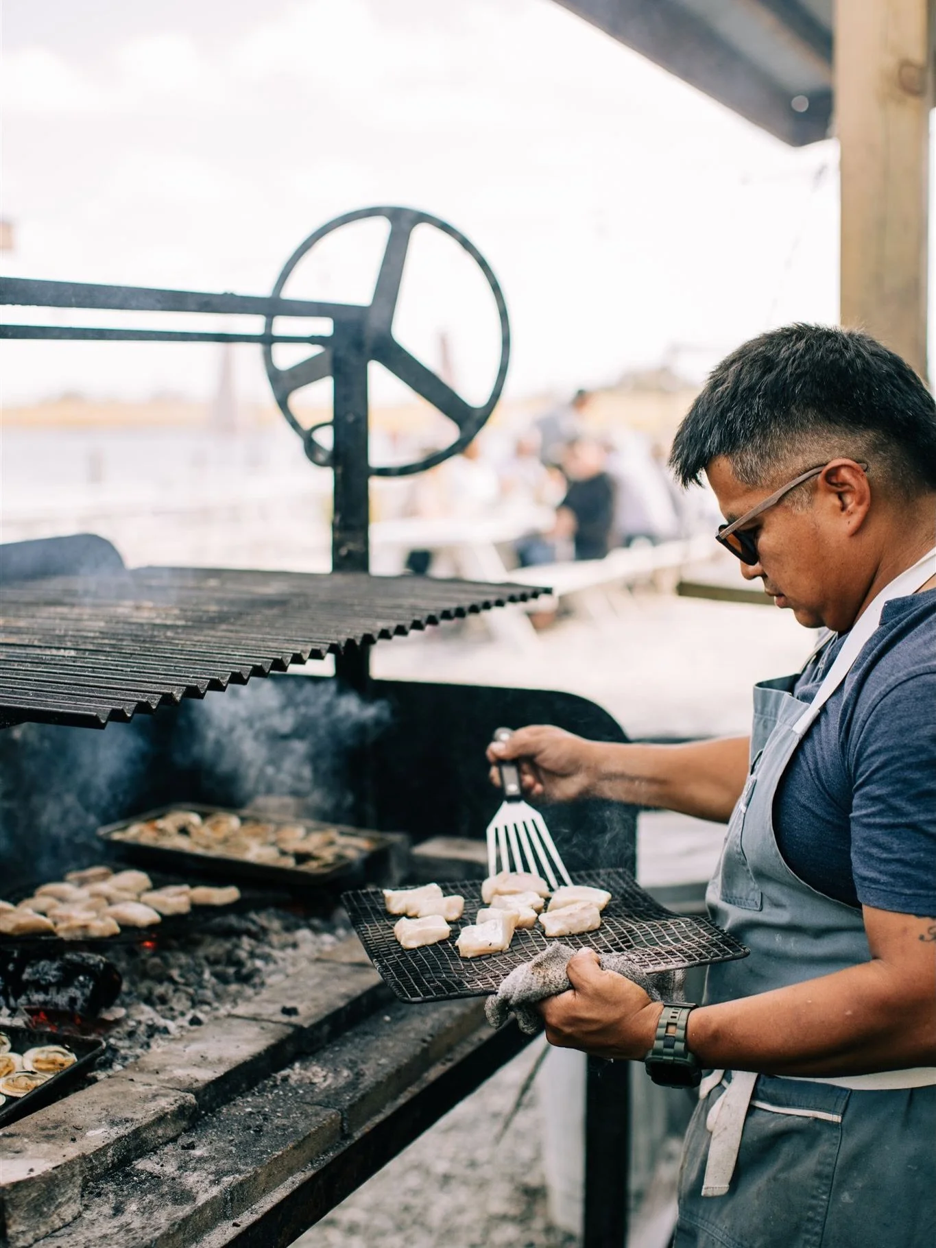 This is where it happens. Wood fire. Salt air. The bay thirty feet away.

This is Chef Pablo Toxqui&rsquo;s kitchen &mdash; open to the sky, built around a fire that he lights every afternoon and tends all through service. Everything that comes off t