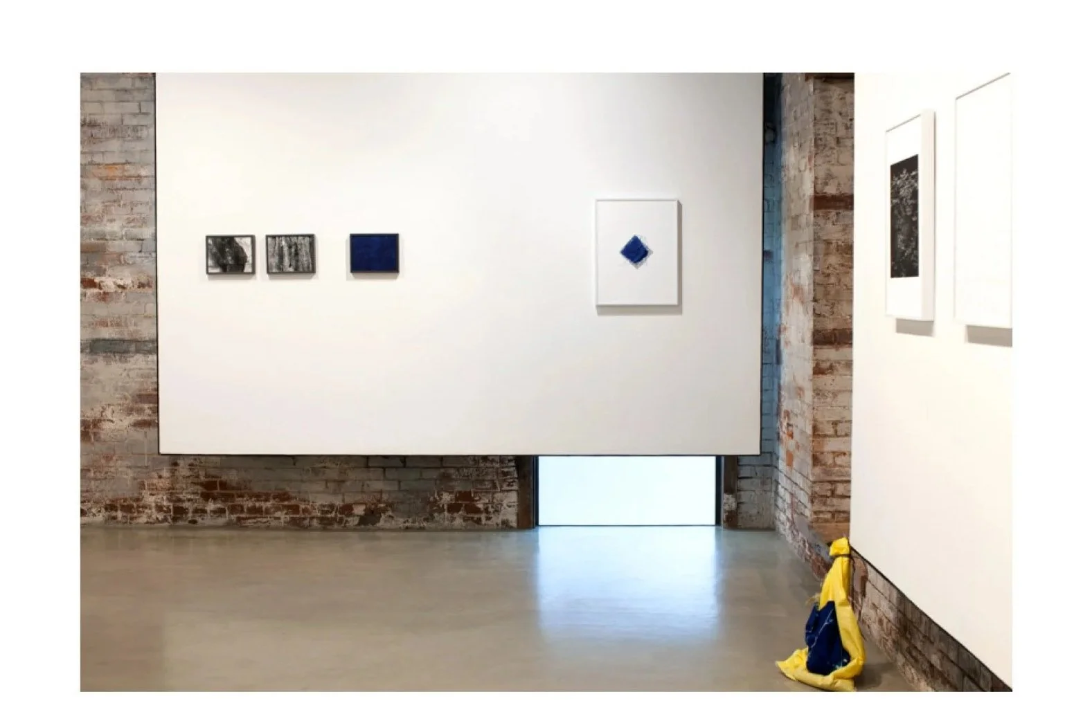 Installation view Sandbagging, archival inket prints, cyanotype, gelatin silver prints, sandbags with praire-toned images, and sand