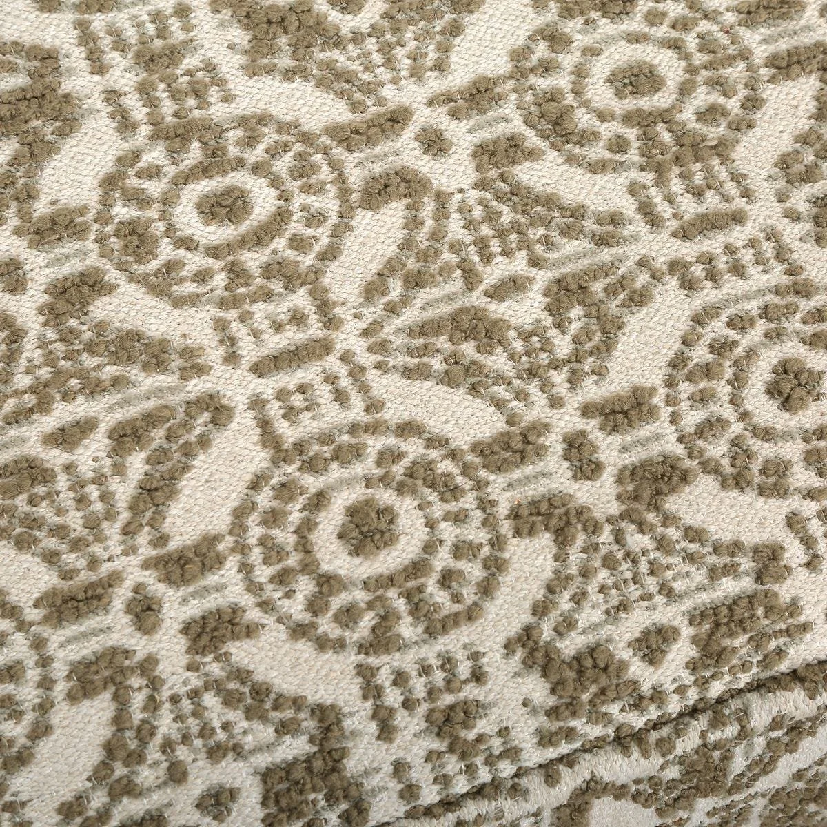 Close-up of textured olive green boucle with medallion lattice motif on Satoria bench