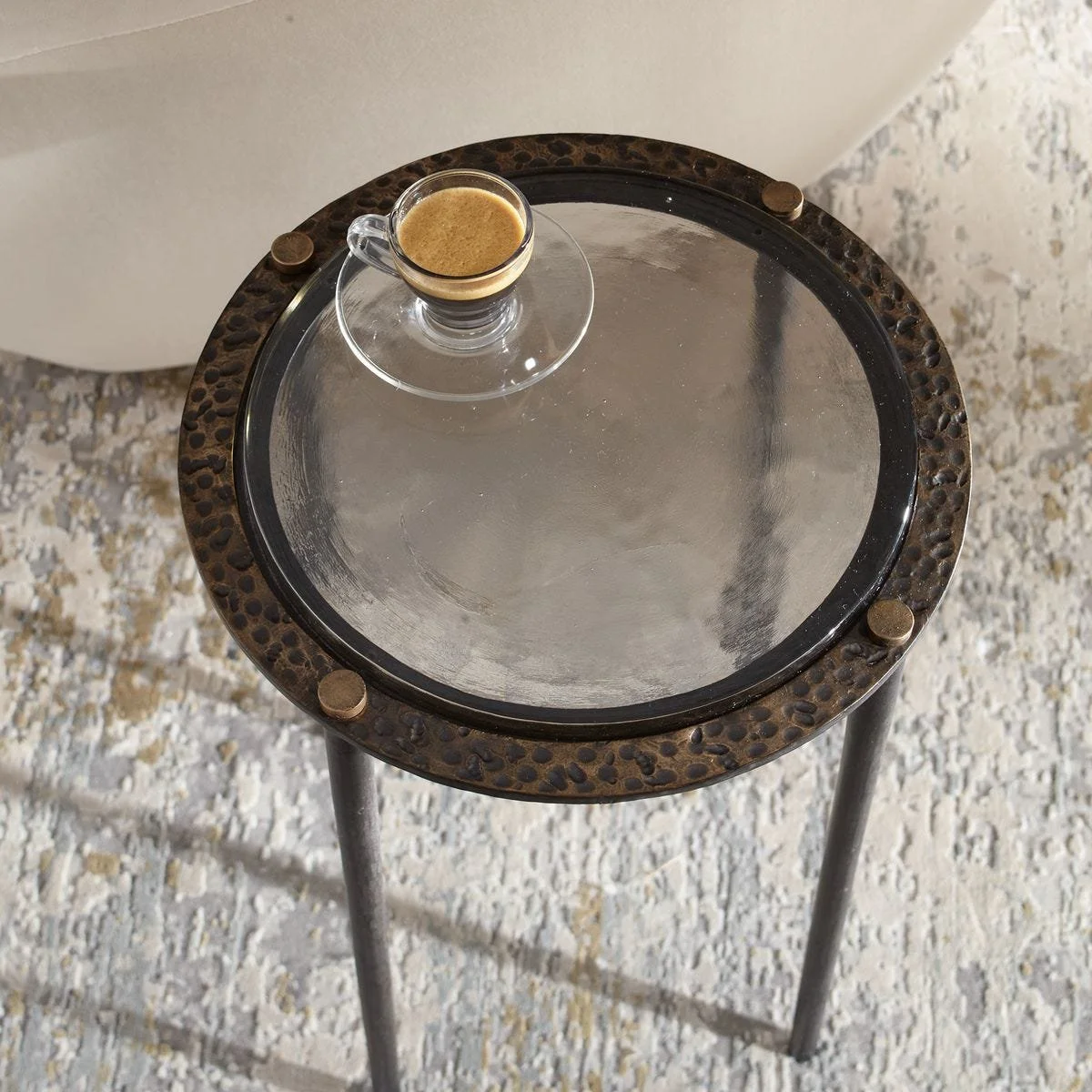 Stylish accent table featuring sculptural cast glass surface and rubbed dark bronze iron base