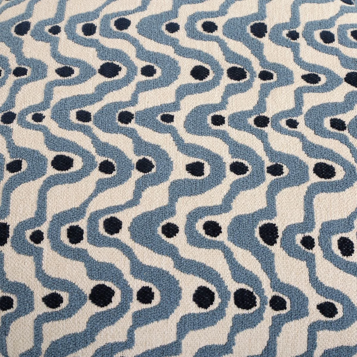 Close-up of plush fabric showing organic steel blue swirls and navy dots