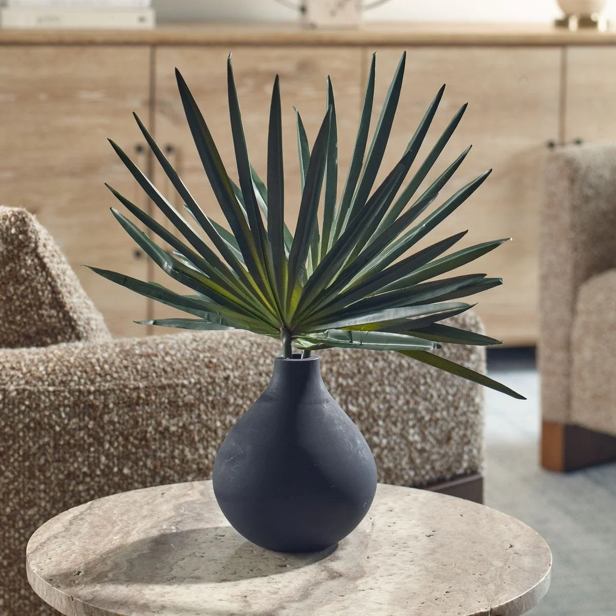Fan palm arrangement in a matte black glass teardrop vase for contemporary interiors