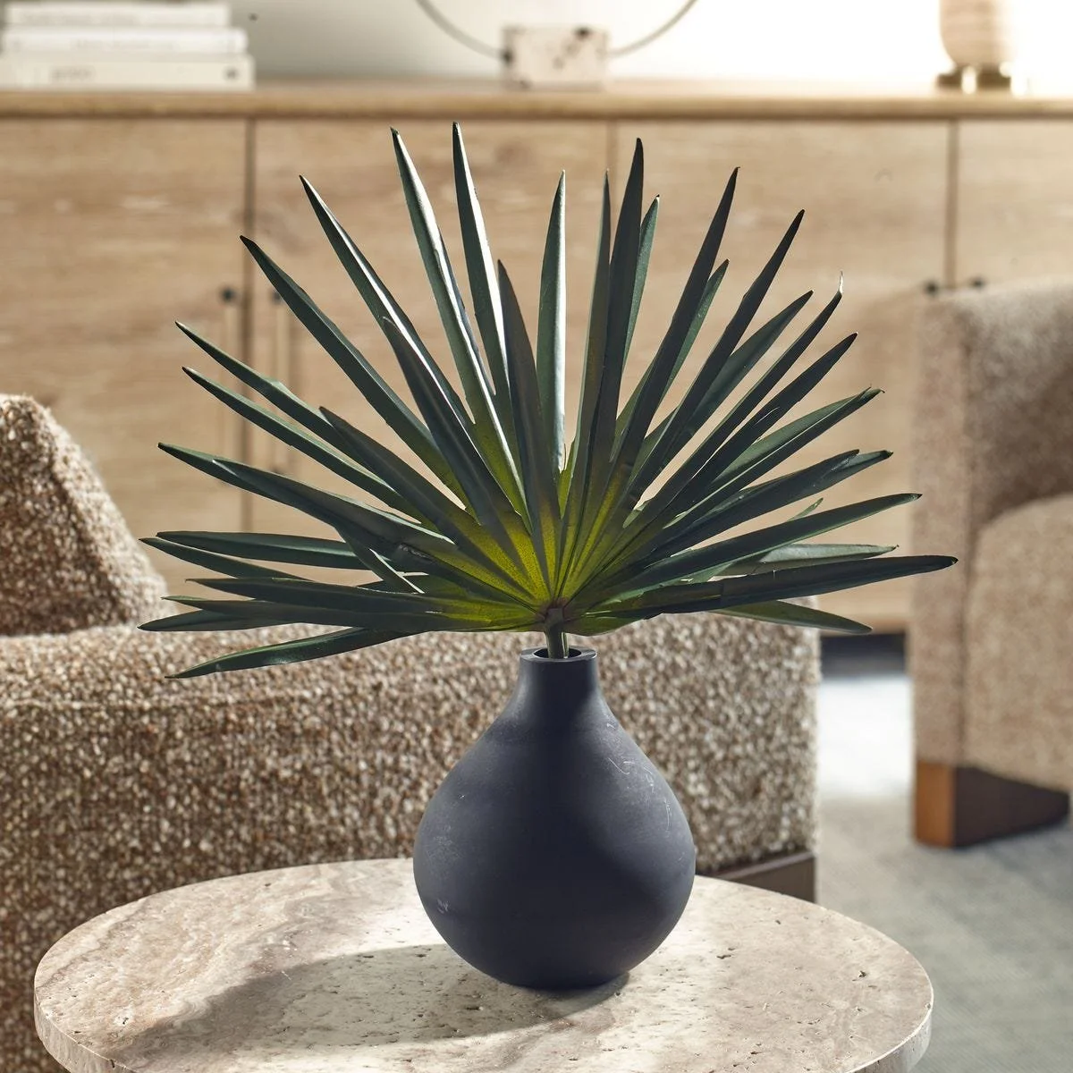 Faux fan palm arrangement styled as modern organic decor on a console or shelf