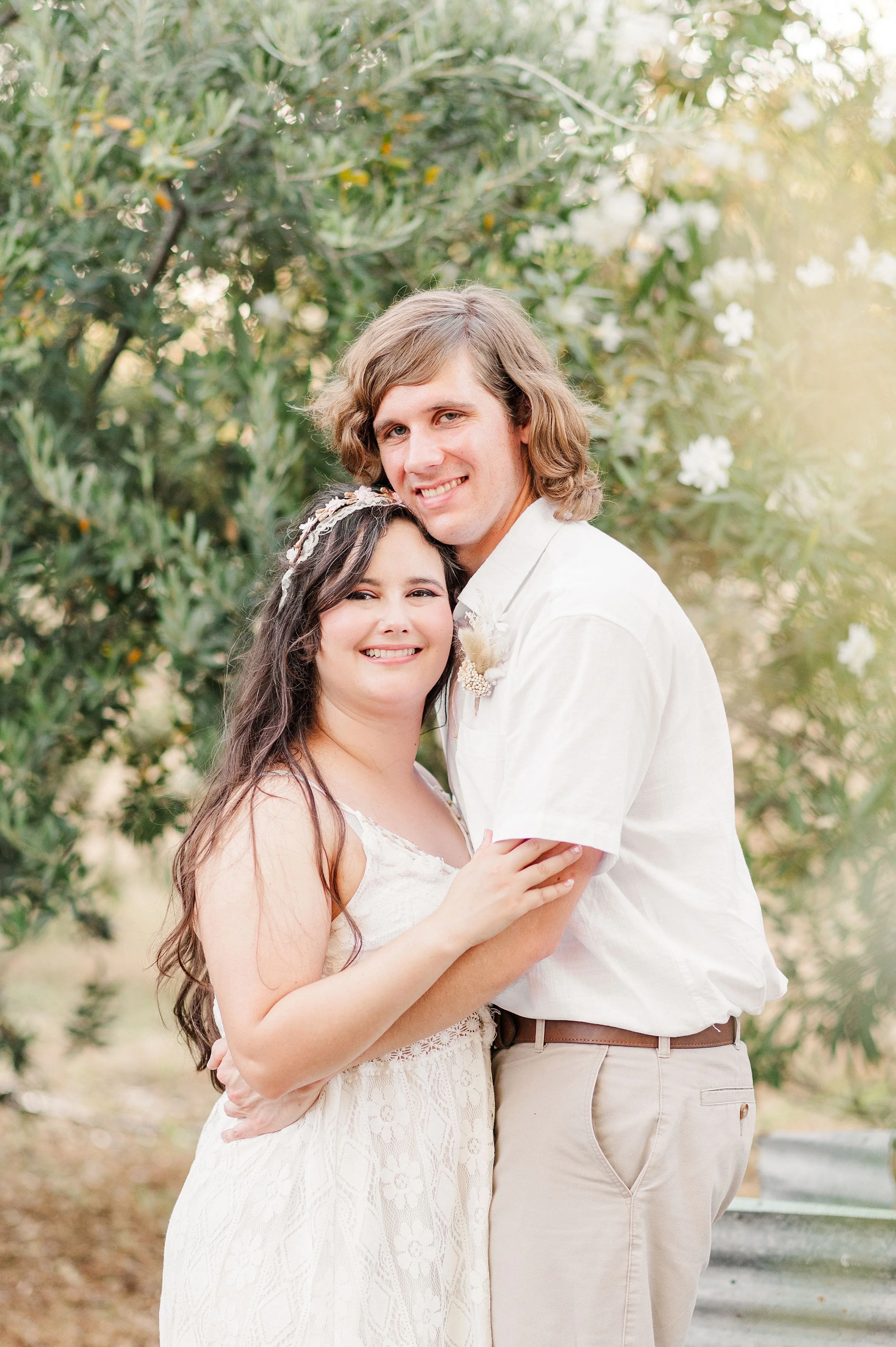 boho styled engagement session with couple smiling towards camera