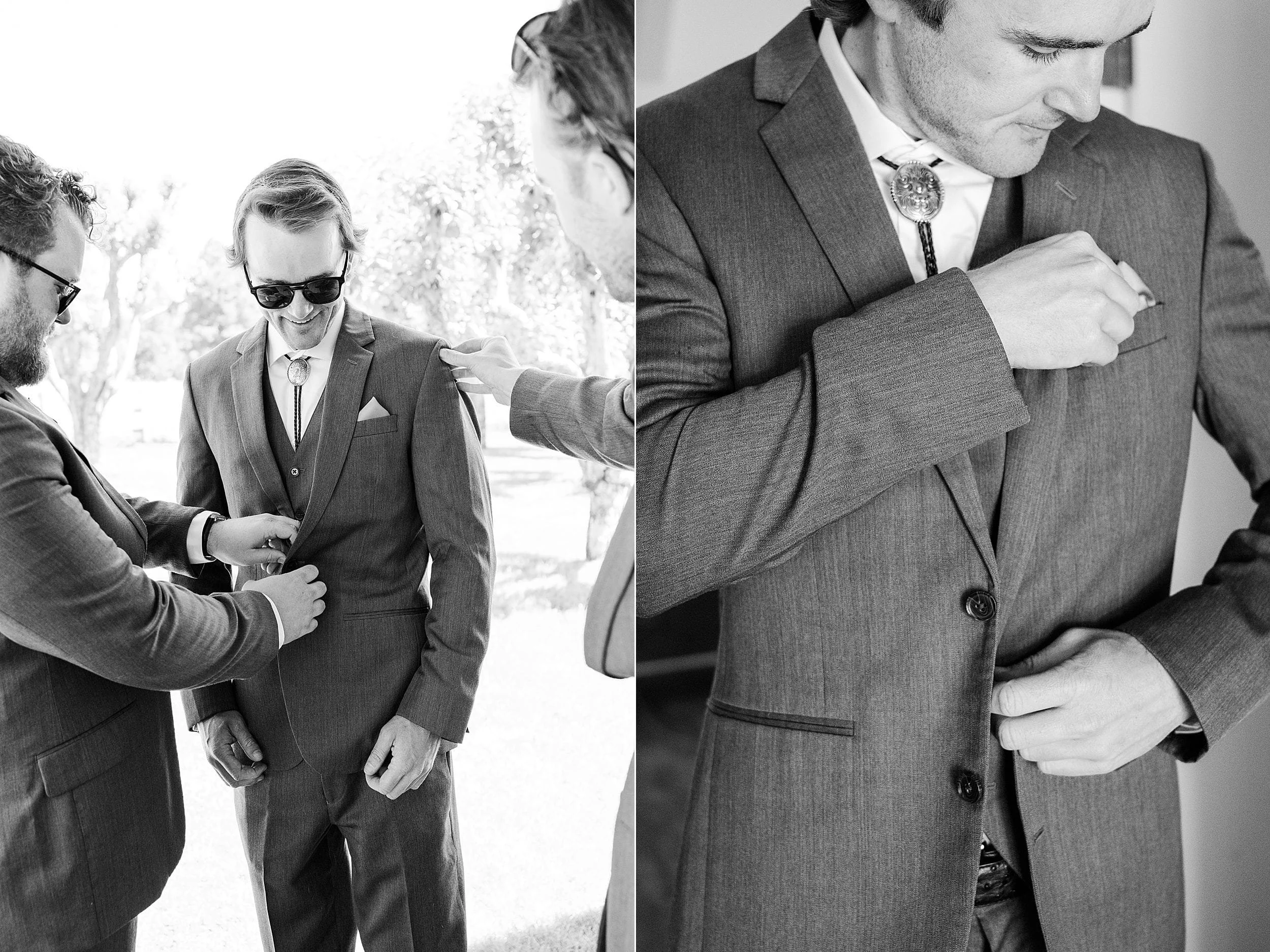 Groom getting ready in a gray suit before his mountain ranch wedding.