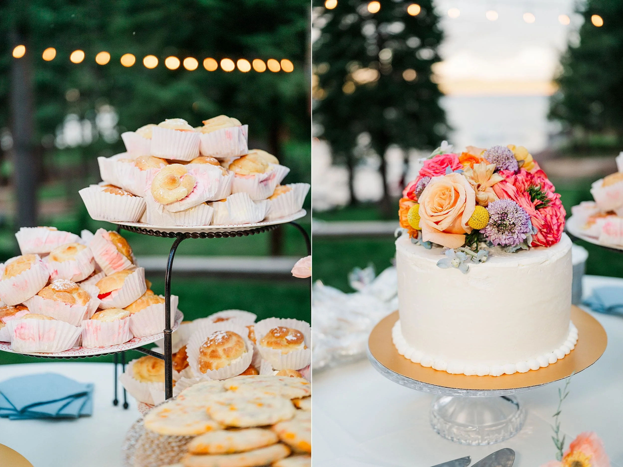 Outdoor wedding dessert display with powdered pastries on a tiered stand beside a white cake topped with a colorful floral bouquet.