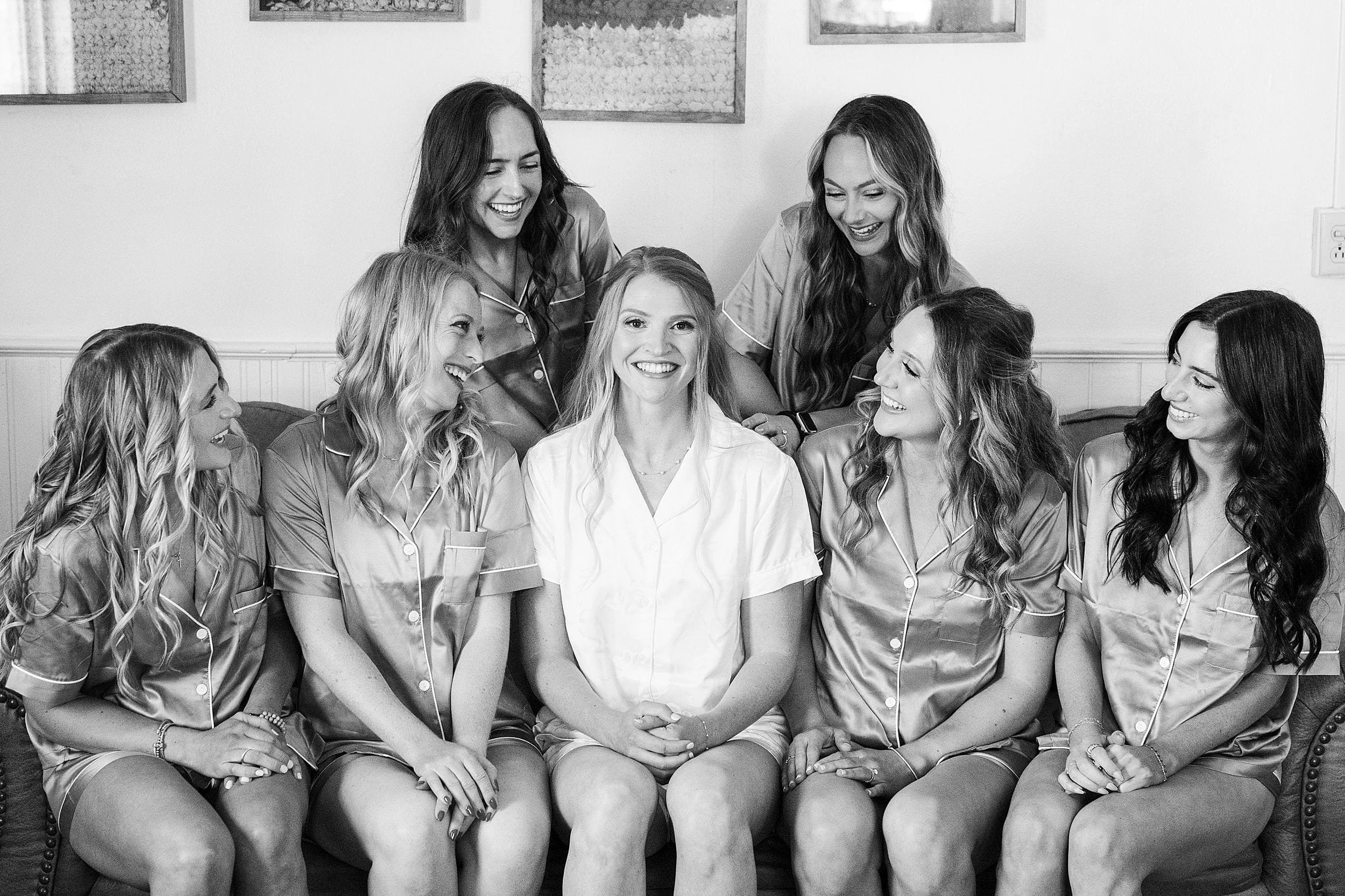 Bride laughing with her bridesmaids before her mountain ranch wedding ceremony.