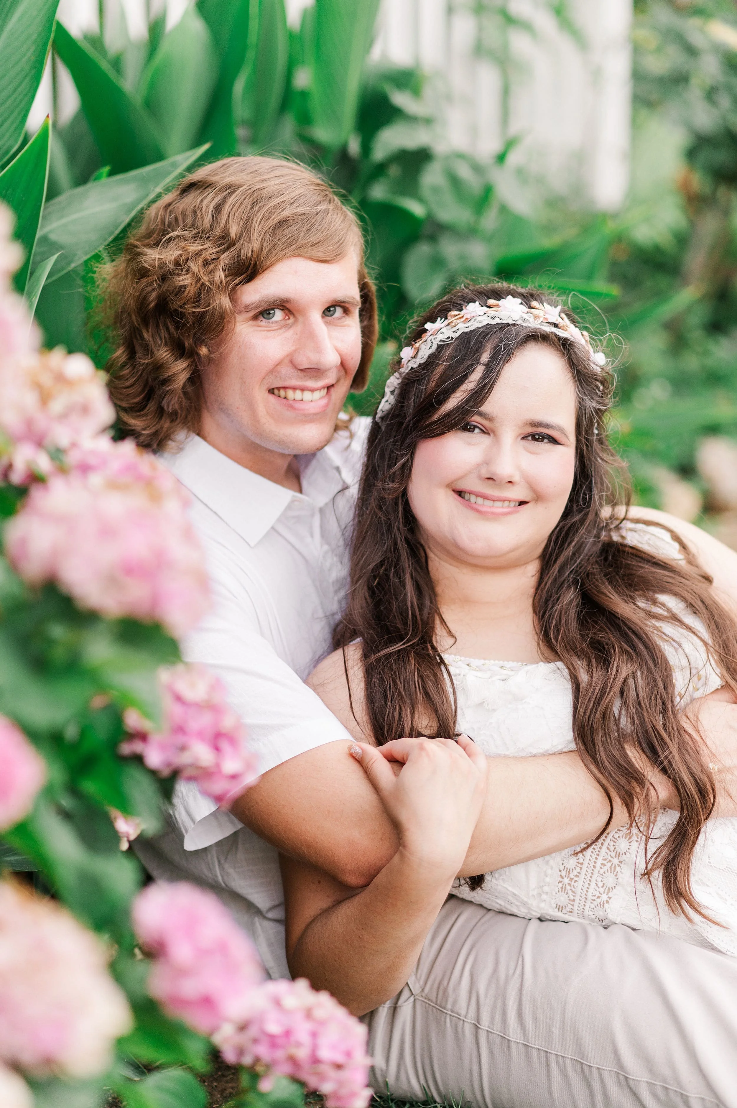engaged couple with pink hydrangea flowers