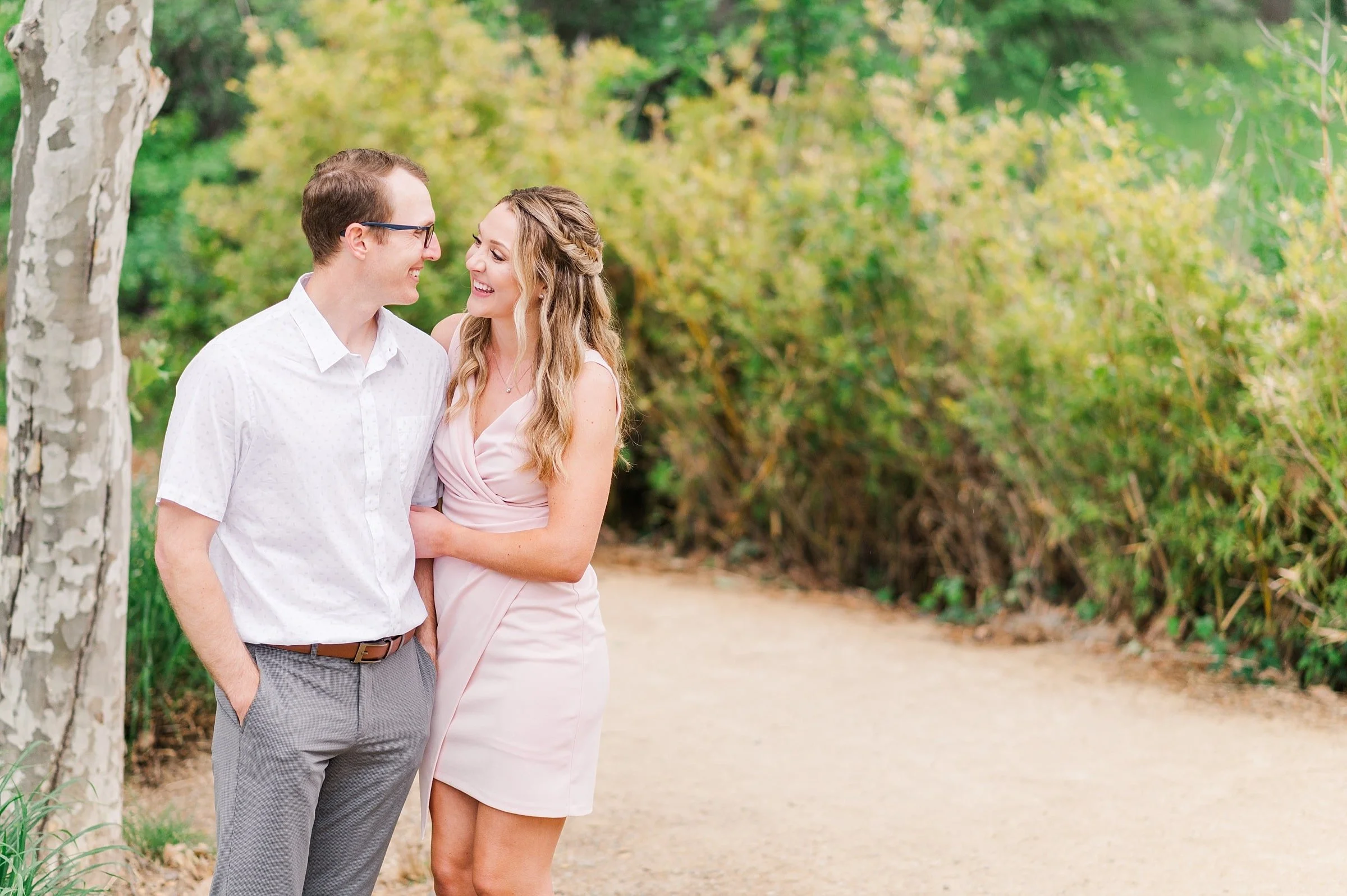 engaged couple wearing gray and blush pink for engagement session