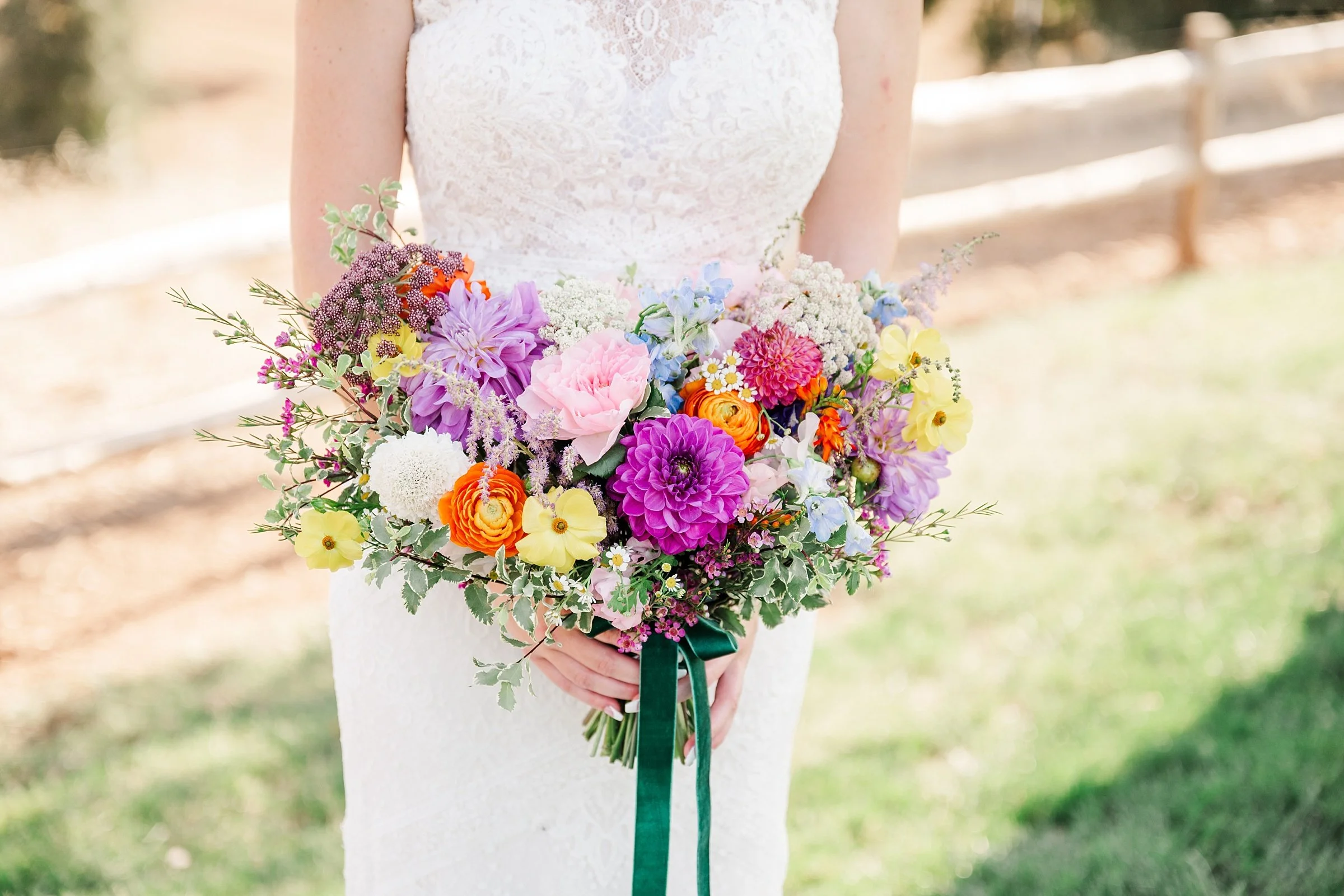 gorgeous bright multi colored wedding bouquet in sweetheart shape with hunter green velvet ribbon