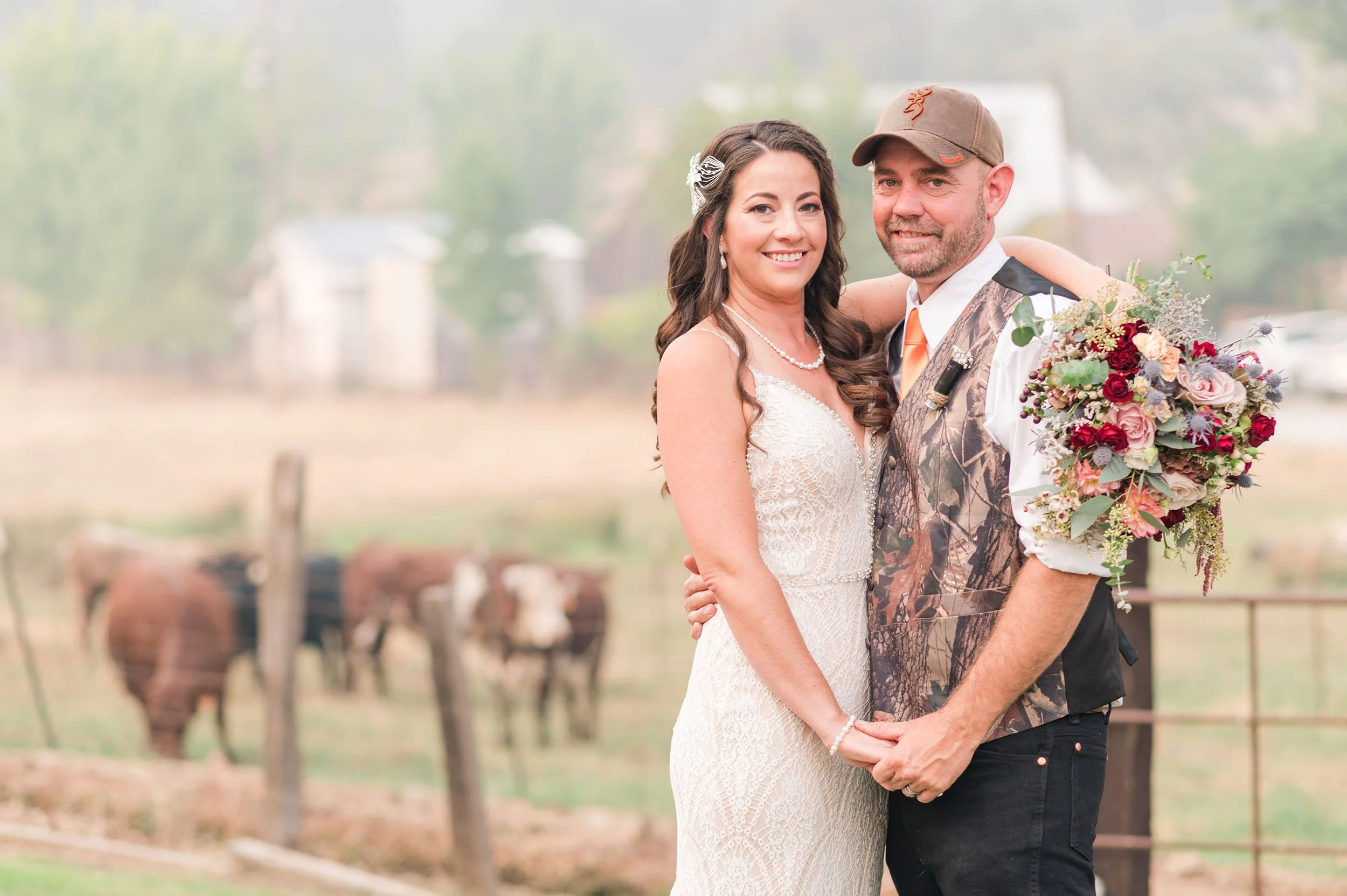 nevada city ranch wedding portrait of bride and groom in front of cow field and smoky skies