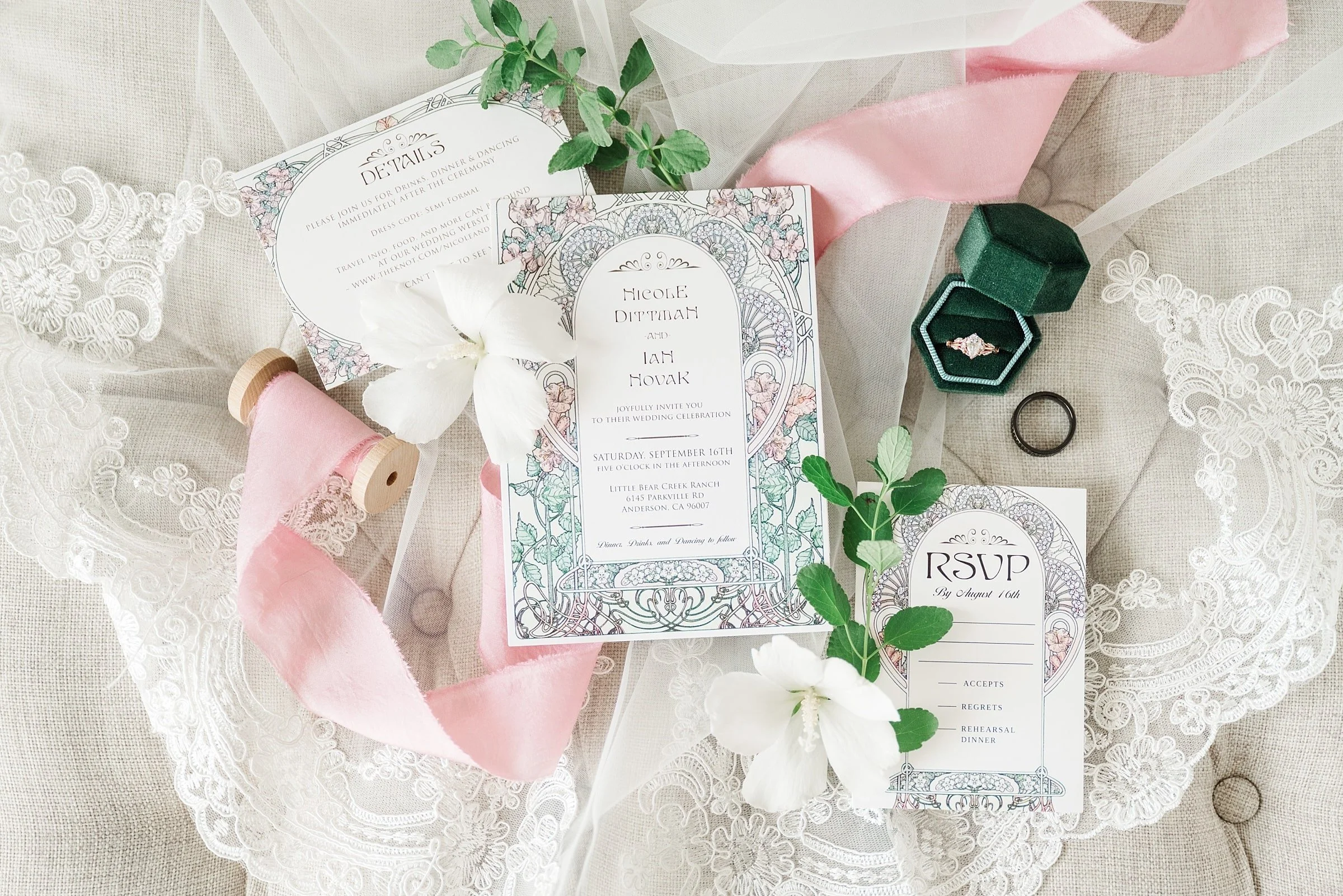 flat lay of vintage wedding invitation with green ring box