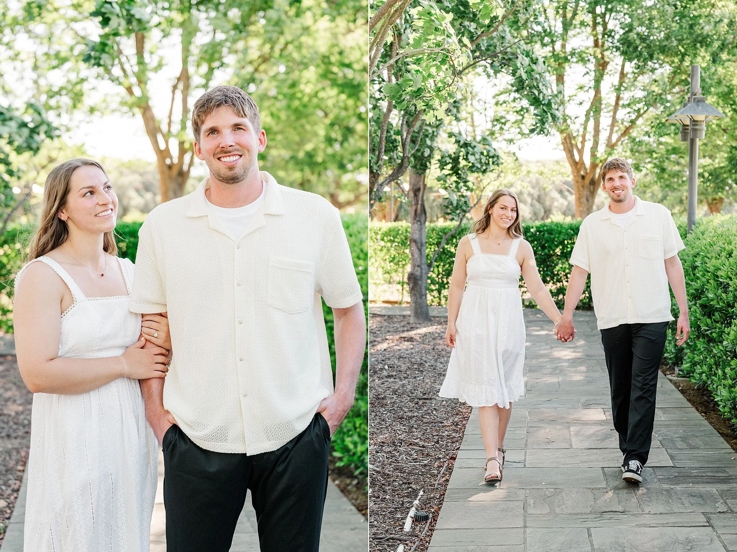 A smiling couple in white attire, walking hand in hand on a sunny garden path, surrounded by lush green trees and hedges, conveying joy and companionship.