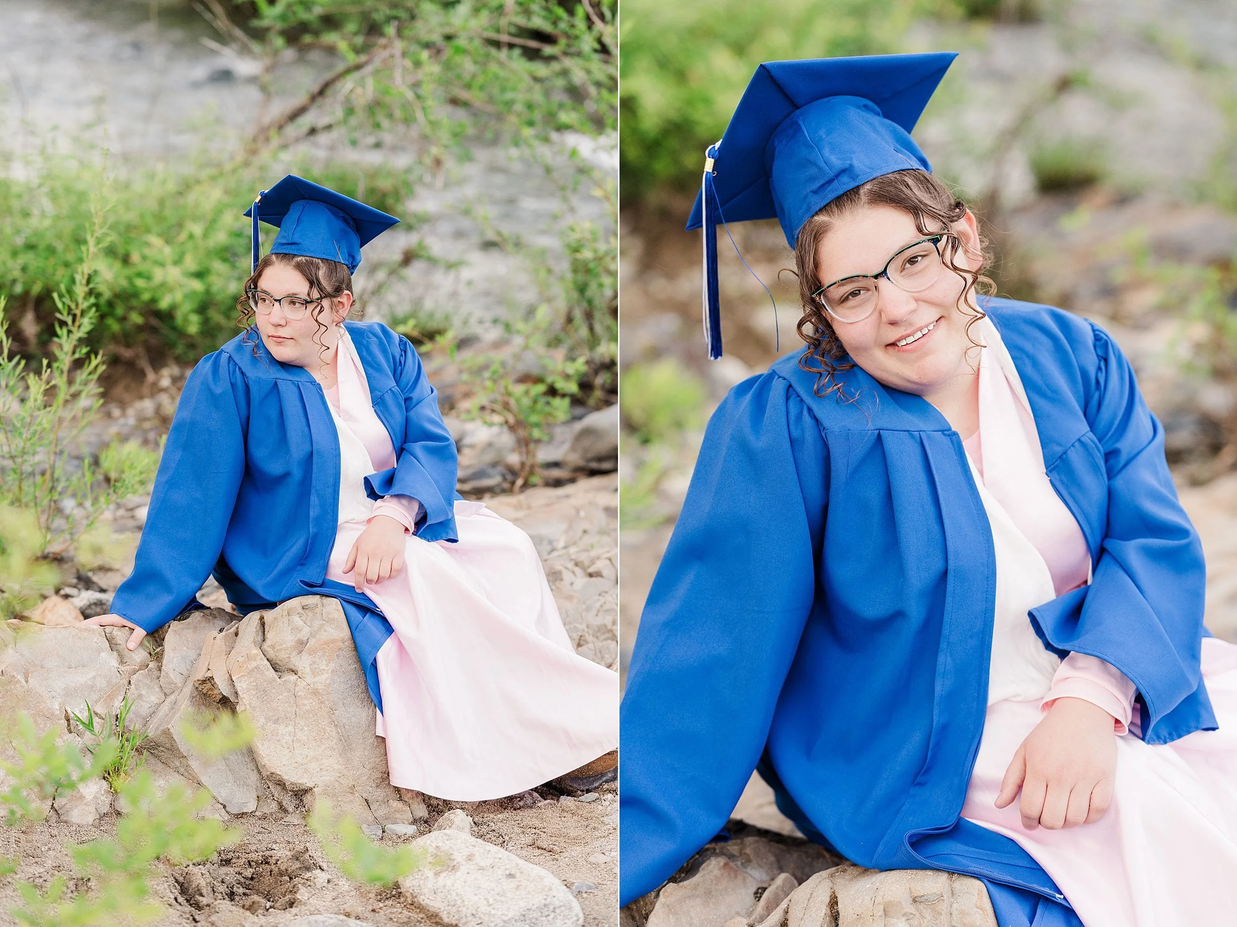 A person in a blue graduation gown and cap sits on rocks by a river. They are smiling, creating a serene and celebratory mood amidst lush greenery.