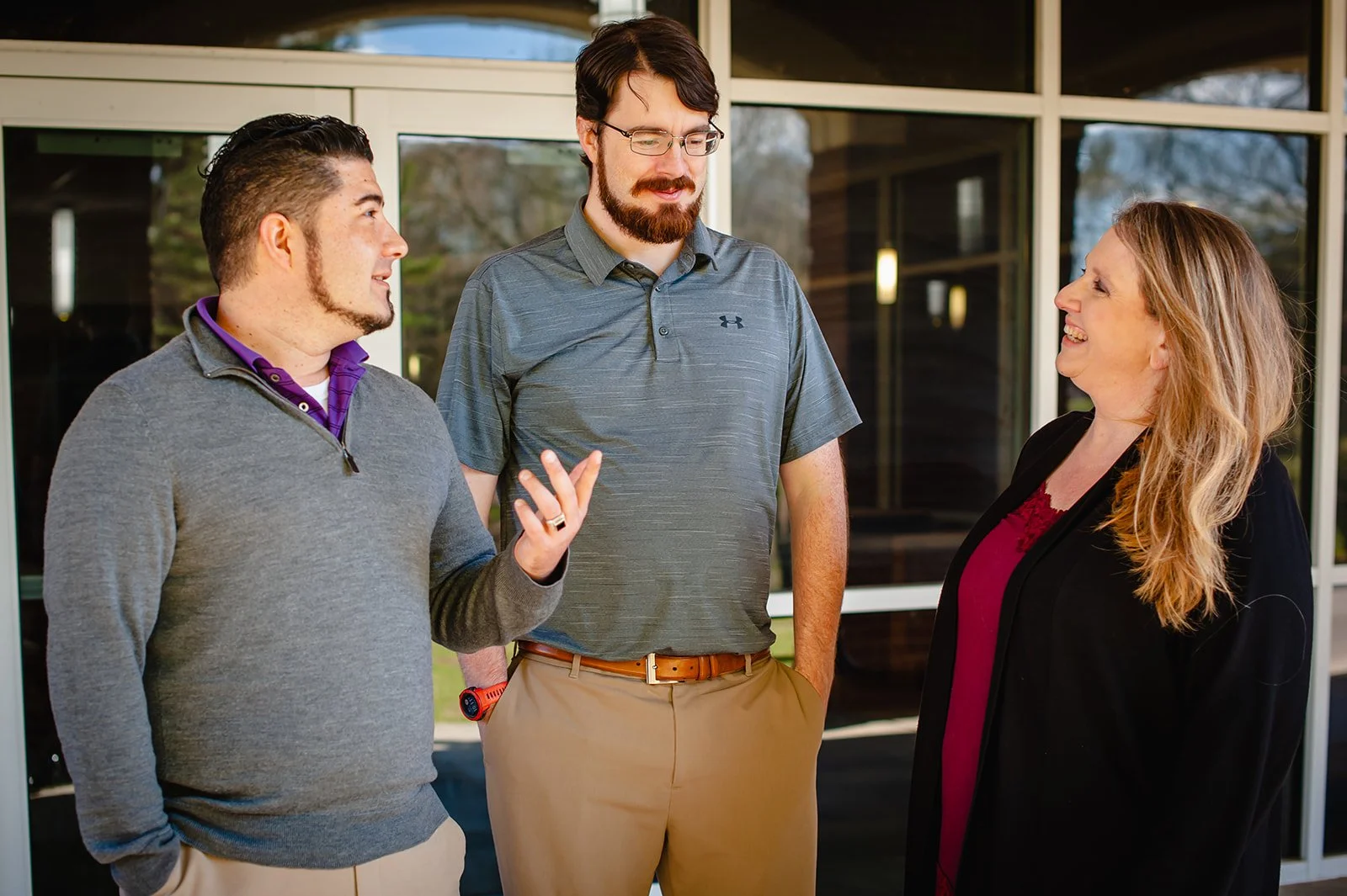 three members of the Ozark team talking with one another