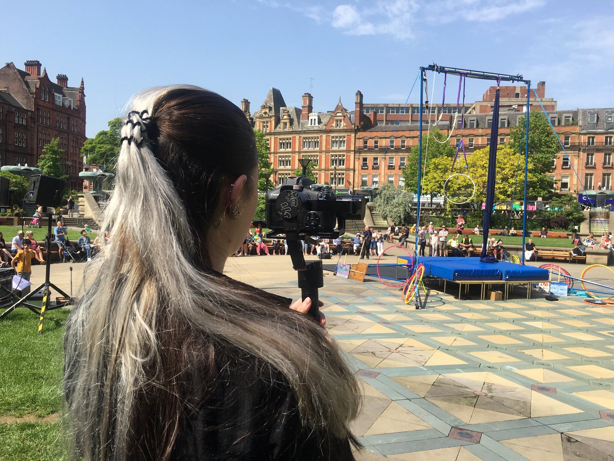 Staff filming the Green Top Circus at Peace Gardens.jpg